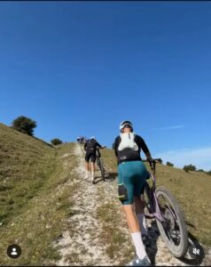 Mountain bikers walking up a steep slope on the South Downs