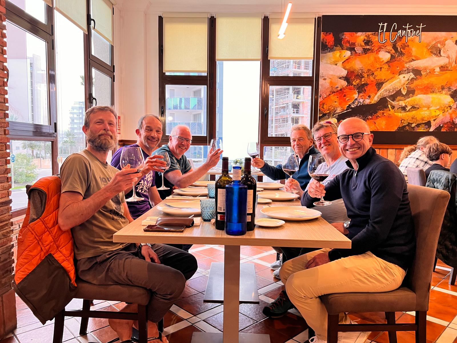 Group in a restaurant raising glasses in a toast